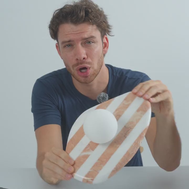 Oscar holding the AX200 striped marble sconce